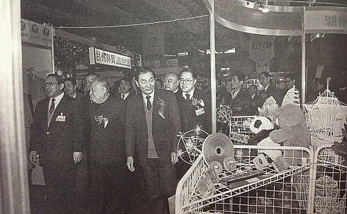1991年3月4日，朱�F基和中国工业经济协会会长吕东（前排左二）、对外经济贸易部部长李岚清（右一）等参观在上海举行的91中国华东出口商品交易会。