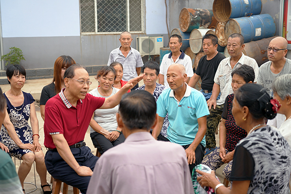 7月20日,王景山(左三)和东梁各庄村的村民们一起探讨村里下一步的产业