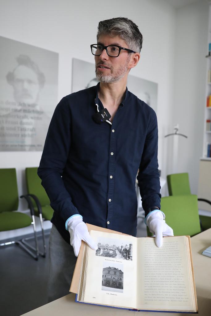 7月30日，在位于德国柏林的西门子历史档案馆，历史学家埃瓦尔德·布勒歇尔展示《拉贝日记》部分原件。新华社记者 杜哲宇 摄